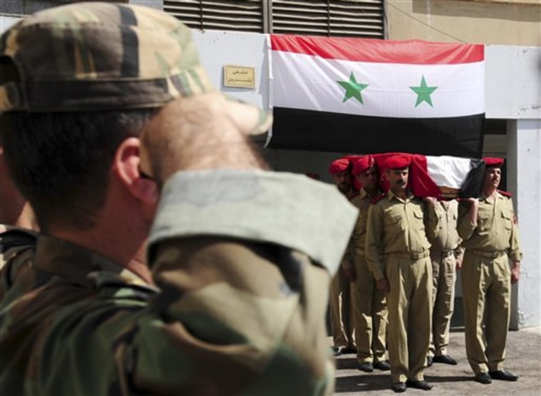 In this photo released by the Syrian official news agency SANA, a Syrian soldier salutes, left, as others carry the coffin of a comrade who was killed in recent violence in the country, during his funeral procession at a hospital in Damascus, Syria, Wednesday July 6, 2011. Syrian security forces may have committed crimes against humanity during a deadly siege of a western town in May, Amnesty International said Wednesday, citing witness accounts of deaths in custody, torture and arbitrary detention. (AP Photo/SANA) EDITORIAL USE ONLY